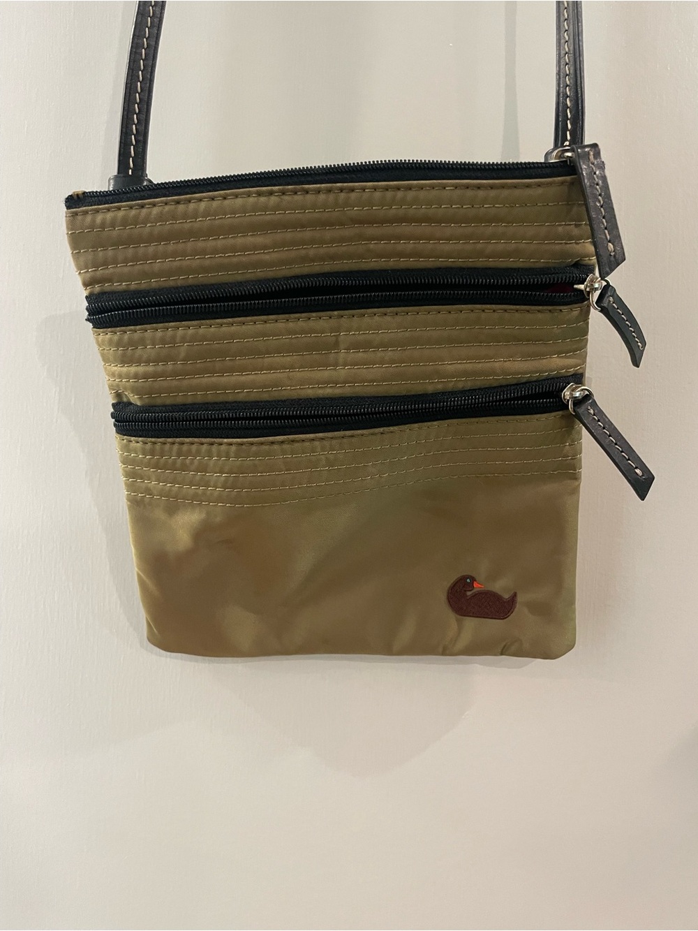 Dooney & Bourke Olive Crossbody Bag with Triple Zip Pockets and leather strap